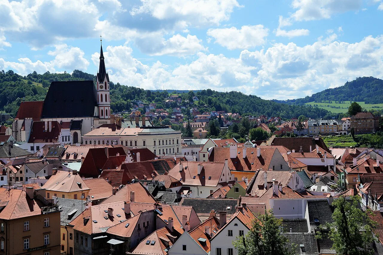 Red rooftops of Český Krumlov with the spire of St. Vitus Church.