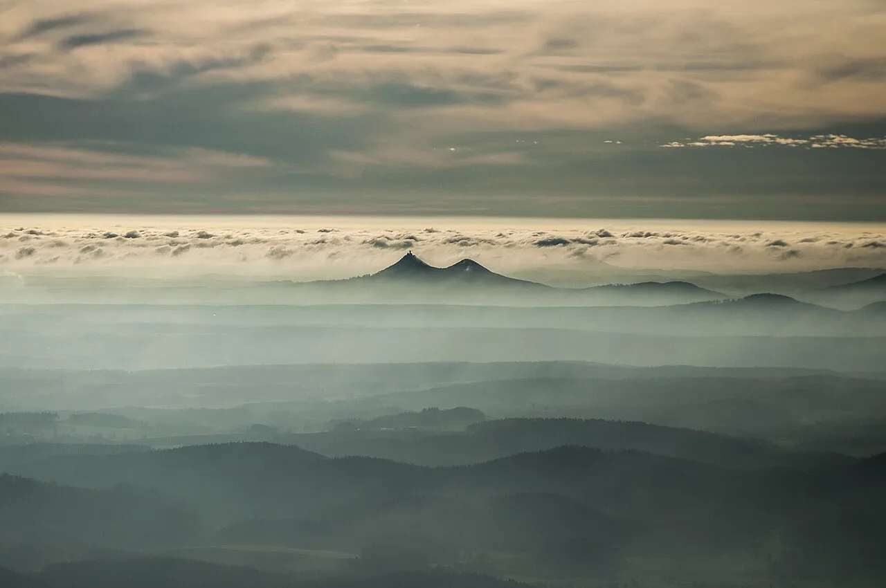 Bezděz hill rising above morning mist in northern Bohemia.