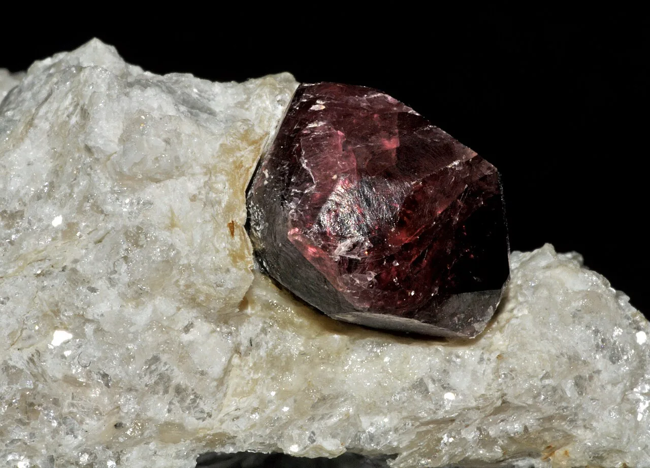 A pyrope garnet crystal on its matrix.