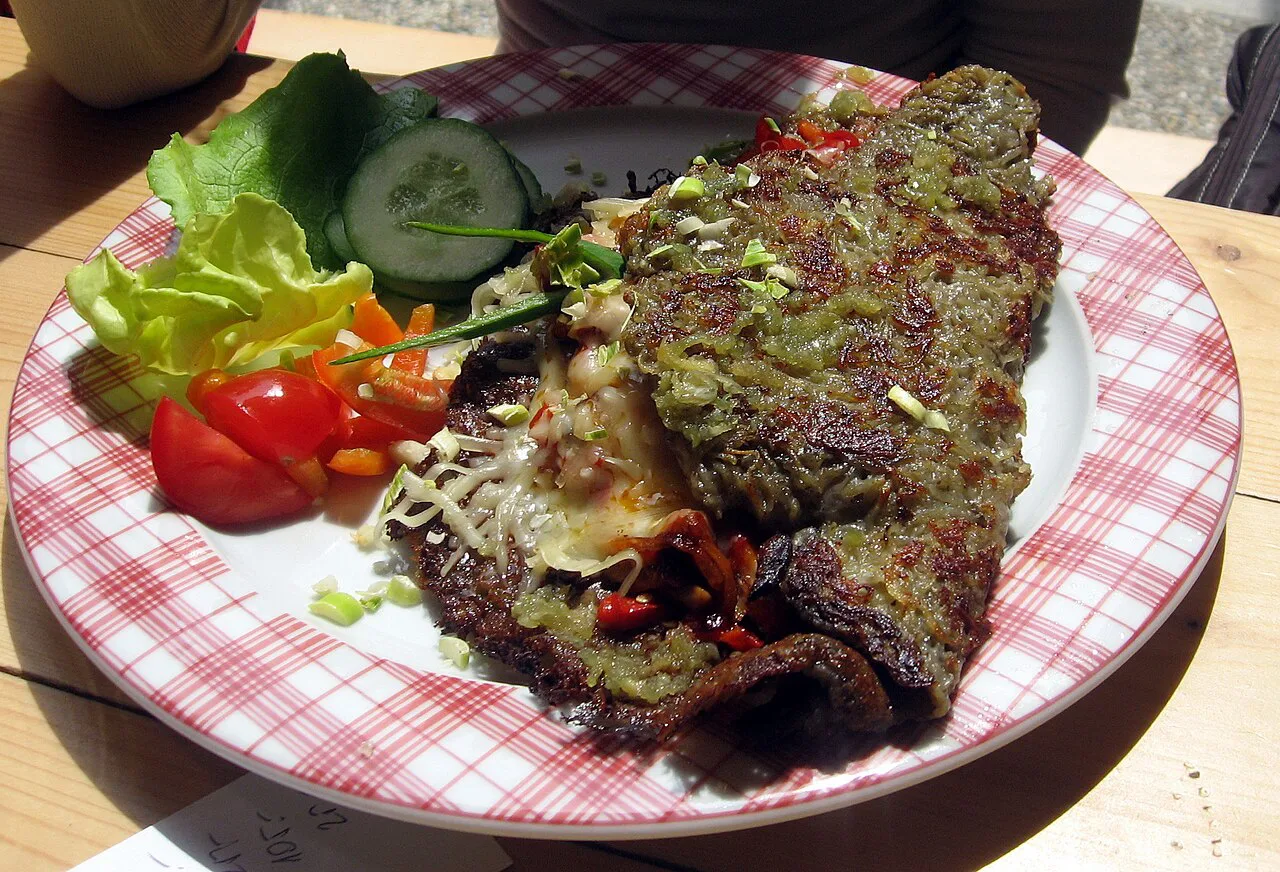 A stuffed bramborák (potato pancake) served with salad.