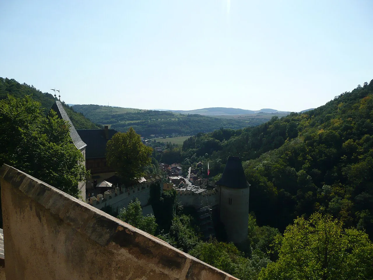 View from the walls of Karlštejn Castle over the wooded hills.