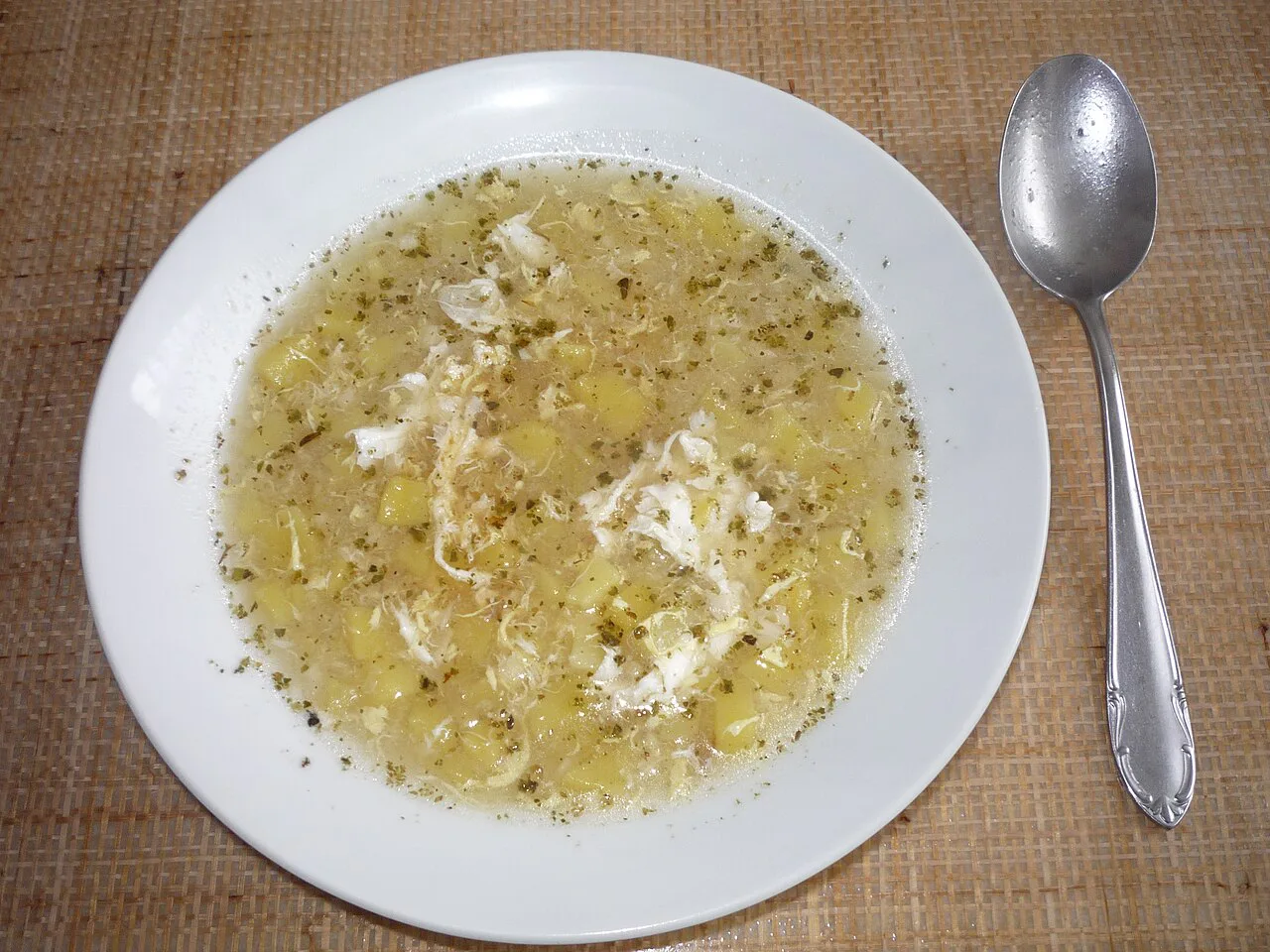 A plate of česneková polévka garlic soup with egg.