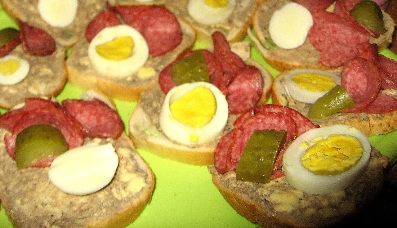 Chlebíčky open sandwiches with salami, egg and pickles.