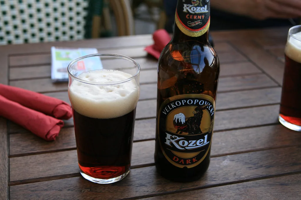 A bottle of Kozel Černý dark lager with a poured glass