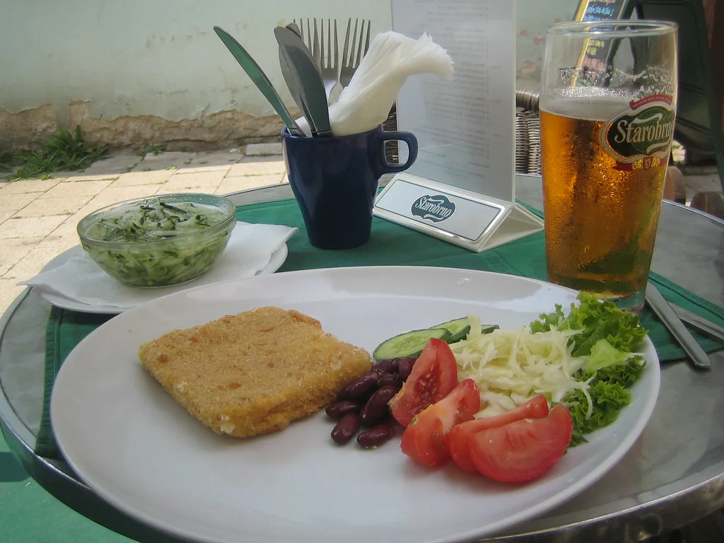 Smažený sýr (fried cheese) served with salad and a beer in Brno