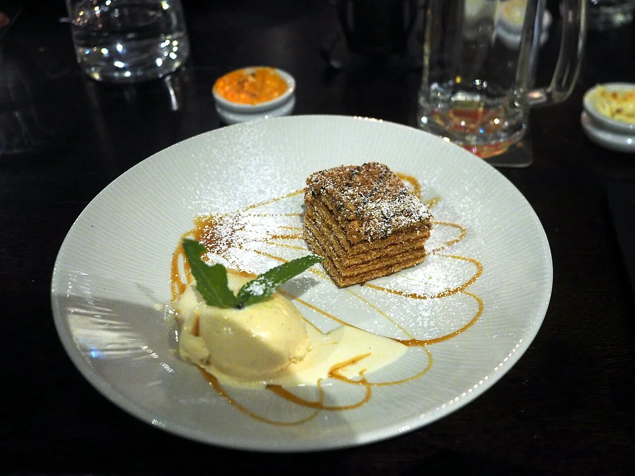 A slice of Marlenka honey cake served at a restaurant.