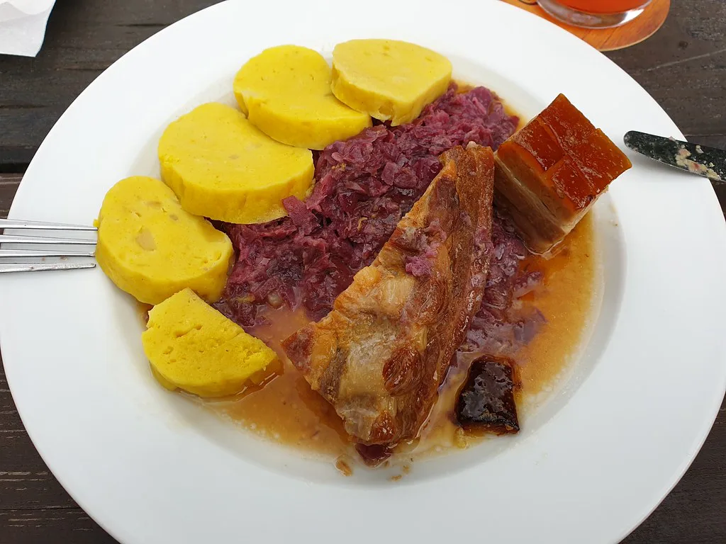 Slow-roasted pork belly with red cabbage and potato dumplings in South Bohemia
