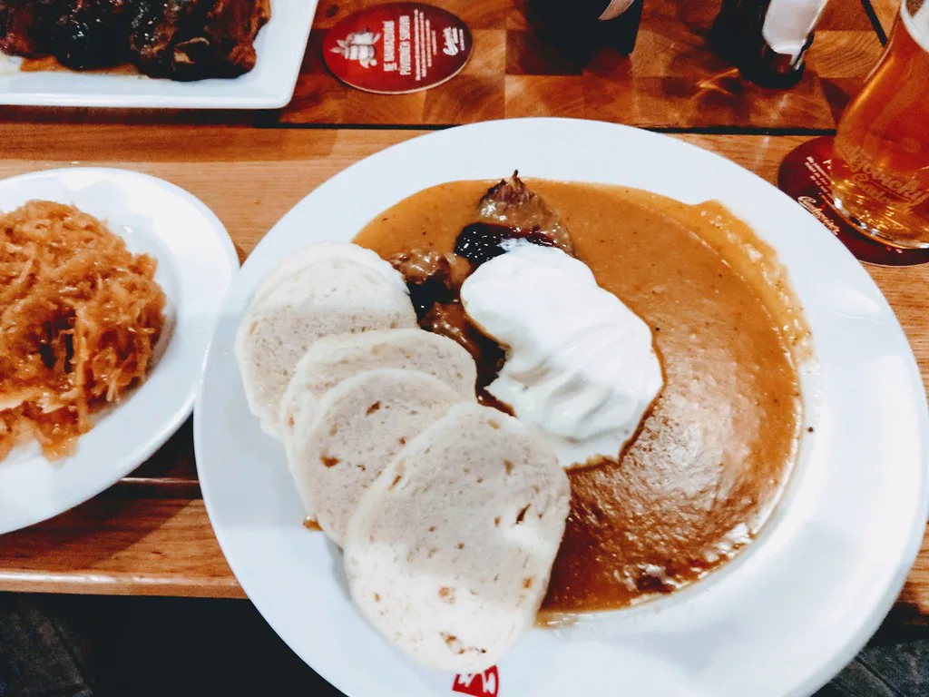 Svíčková na smetaně with bread dumplings, whipped cream and cranberries in České Budějovice