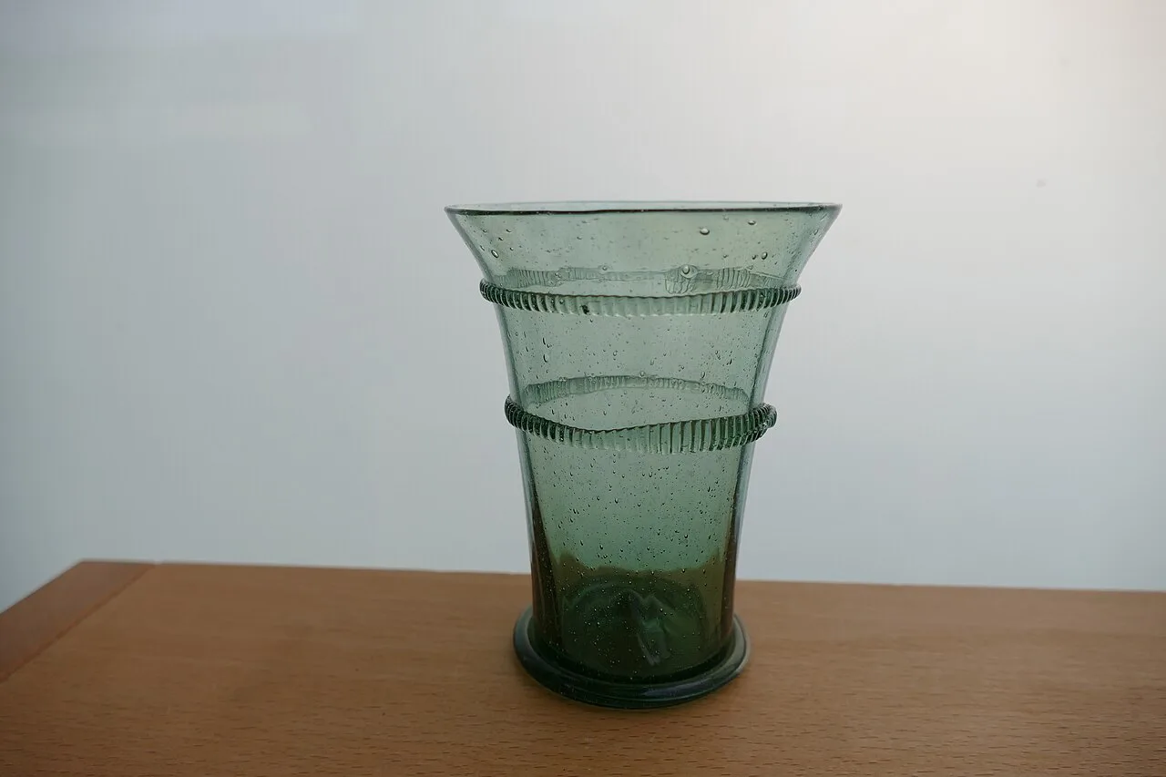 A green Bohemian drinking glass made with traditional methods.