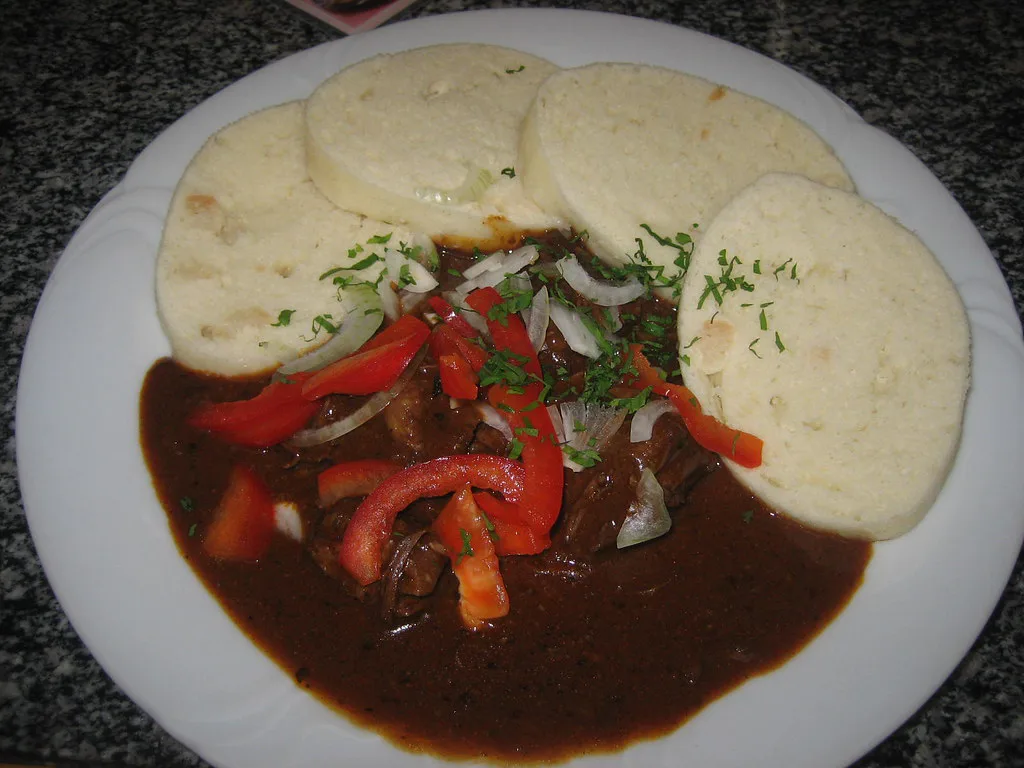 Beef goulash with bread dumplings, onion and peppers