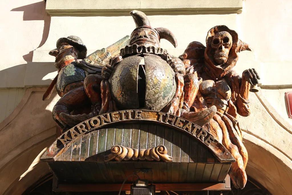 Carved figures above the entrance to a marionette theater in Prague