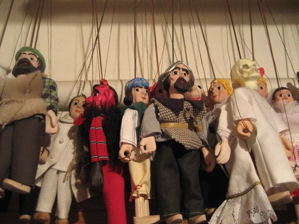 Hand-carved wooden marionettes hanging for sale in Prague