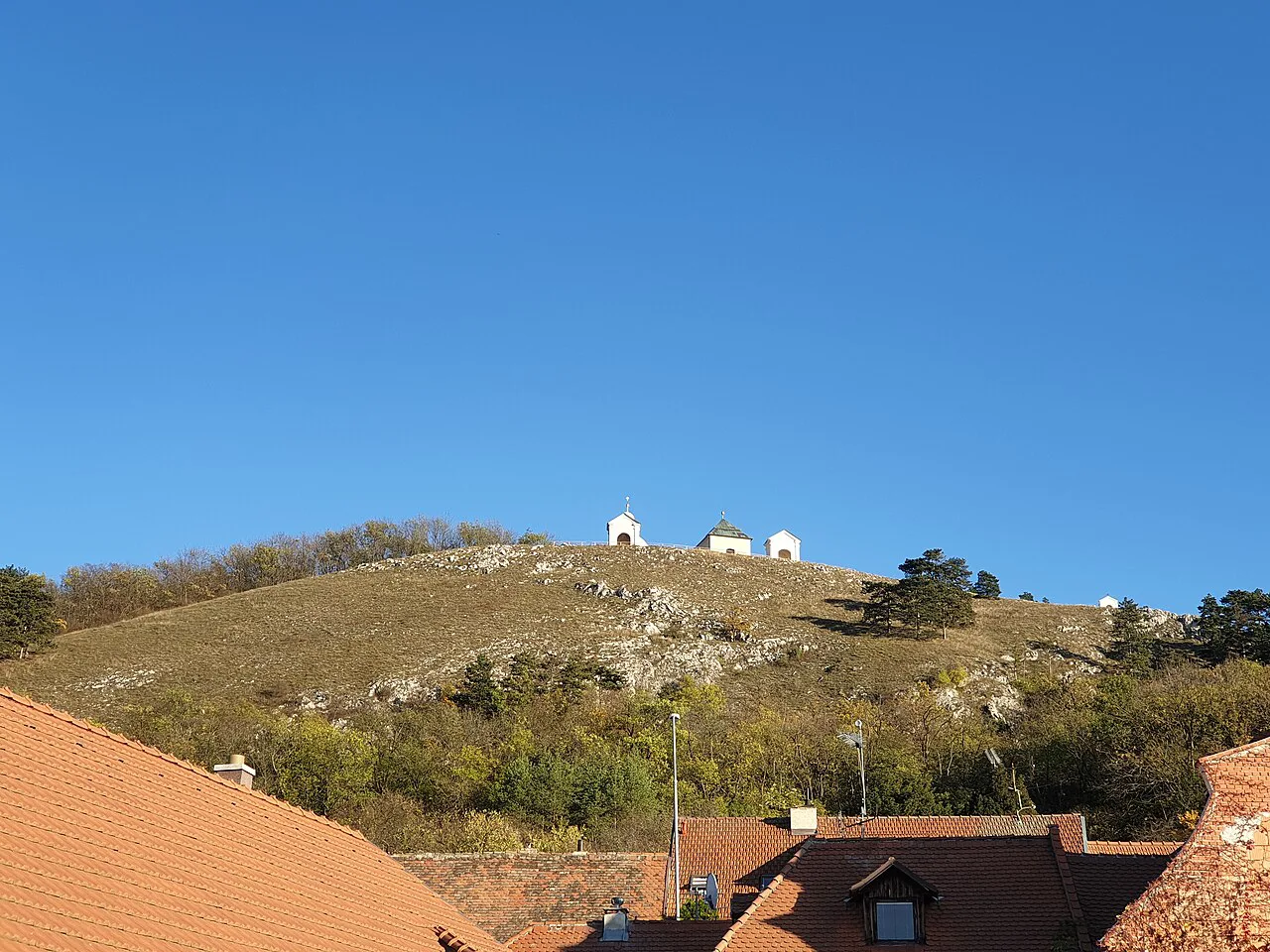 Svatý kopeček (Holy Hill) rising above the rooftops of Mikulov.