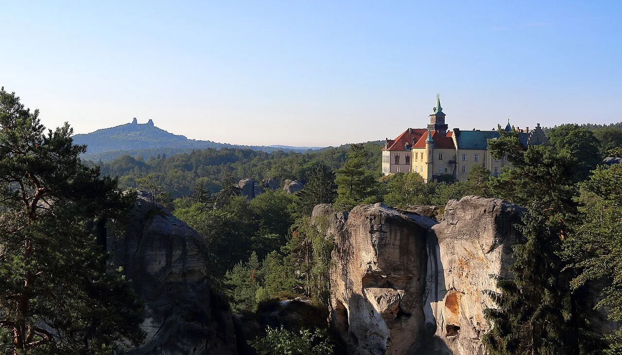 Hrubá Skála Castle above the rock towers, with the Trosky ruin on the horizon.