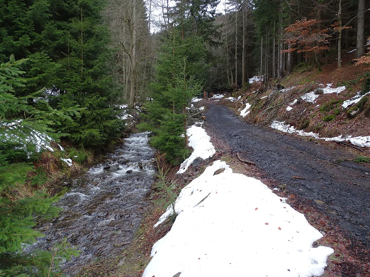 Stísněný potok stream in Jáchymov with patches of snow