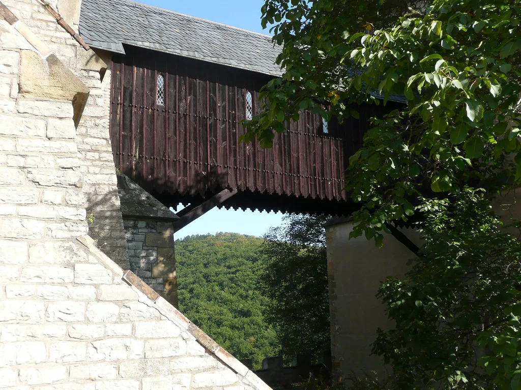 Covered wooden walkway between the stone towers of Karlštejn Castle