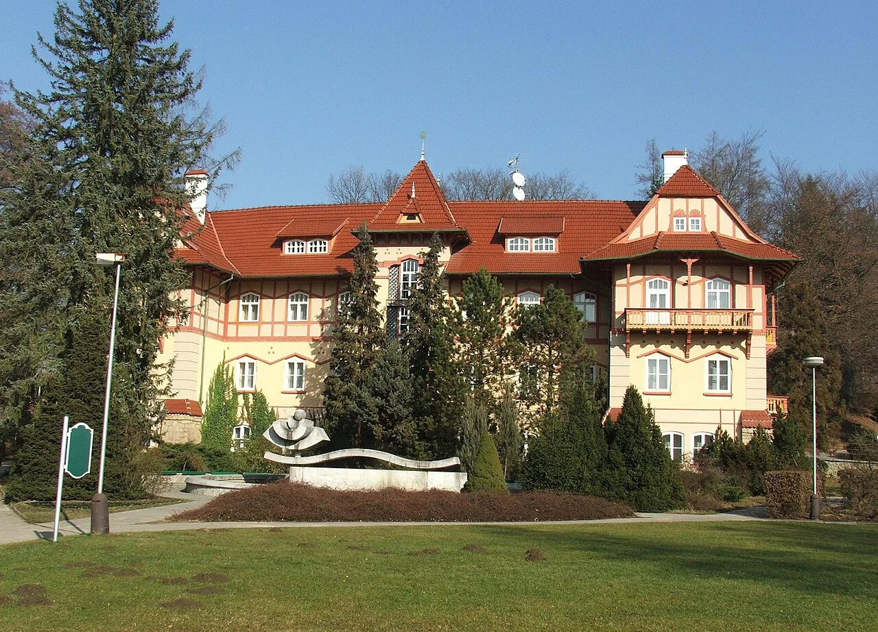 A red-roofed spa house among trees in Luhačovice.
