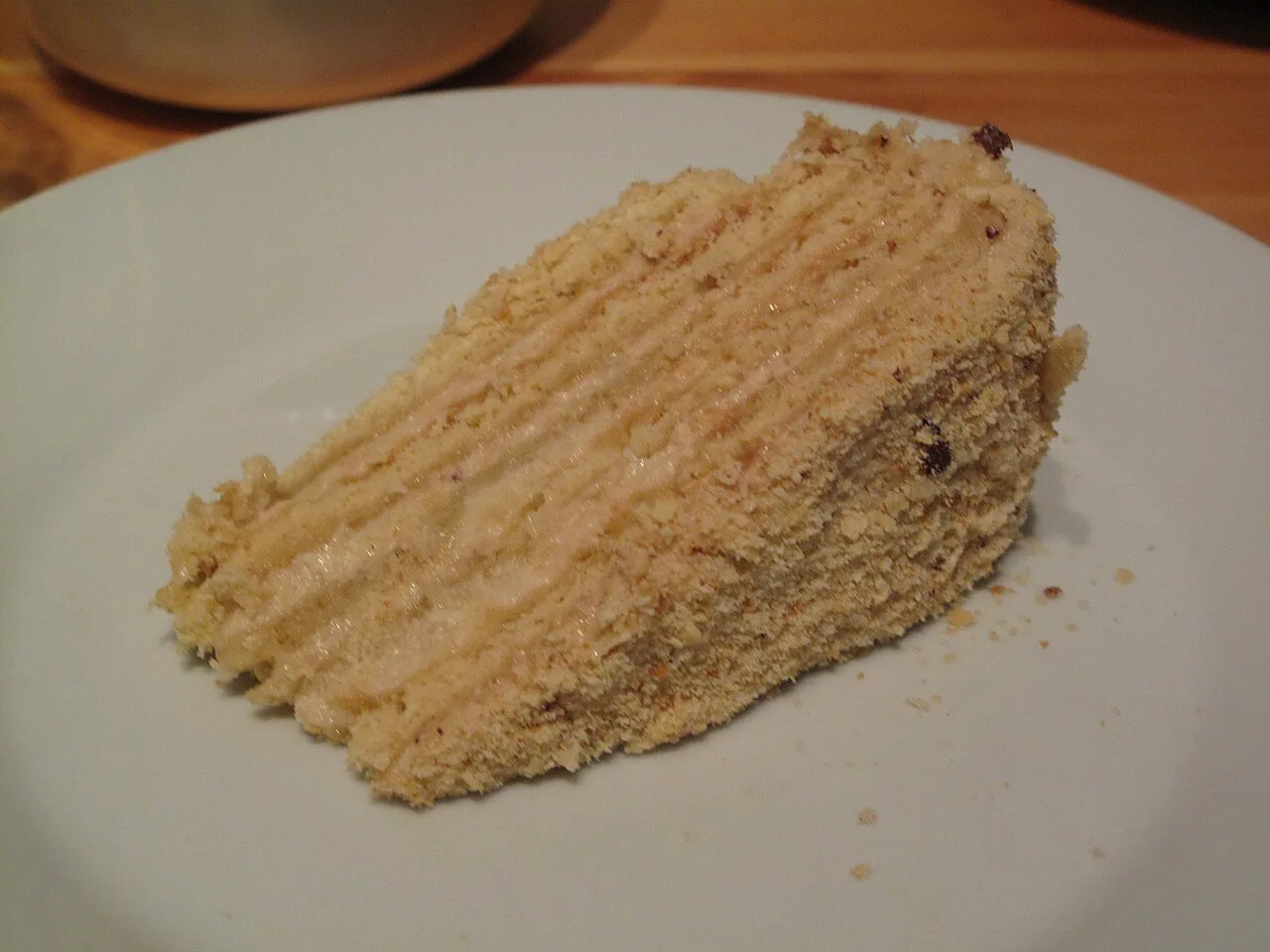 A slice of homemade medovník showing its thin honey layers.