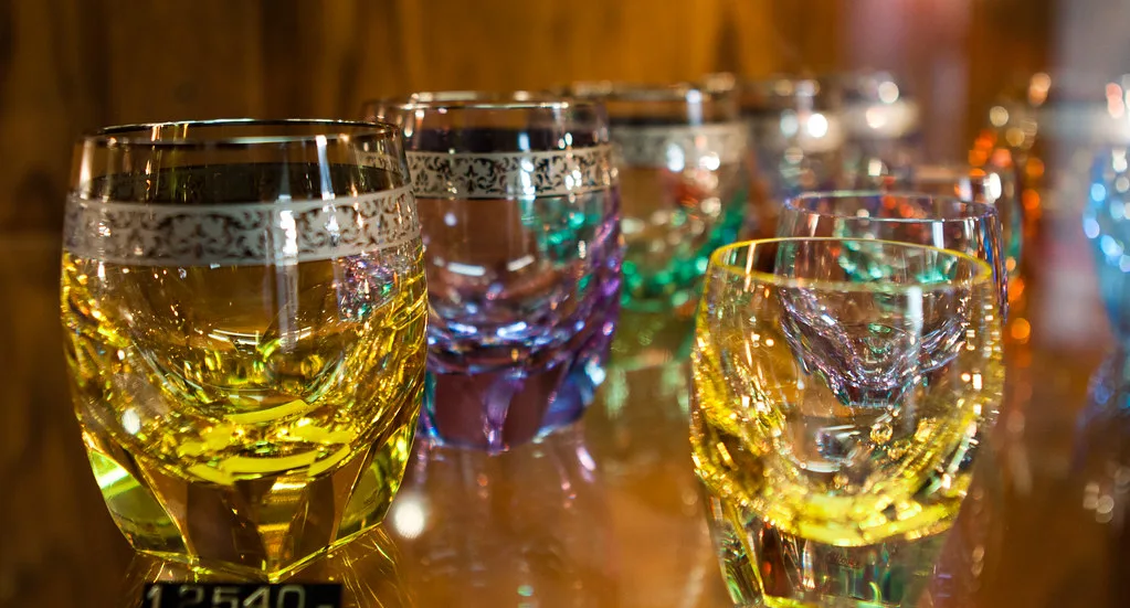 Colored cut-glass tumblers with gilded rims on display at Moser in Karlovy Vary
