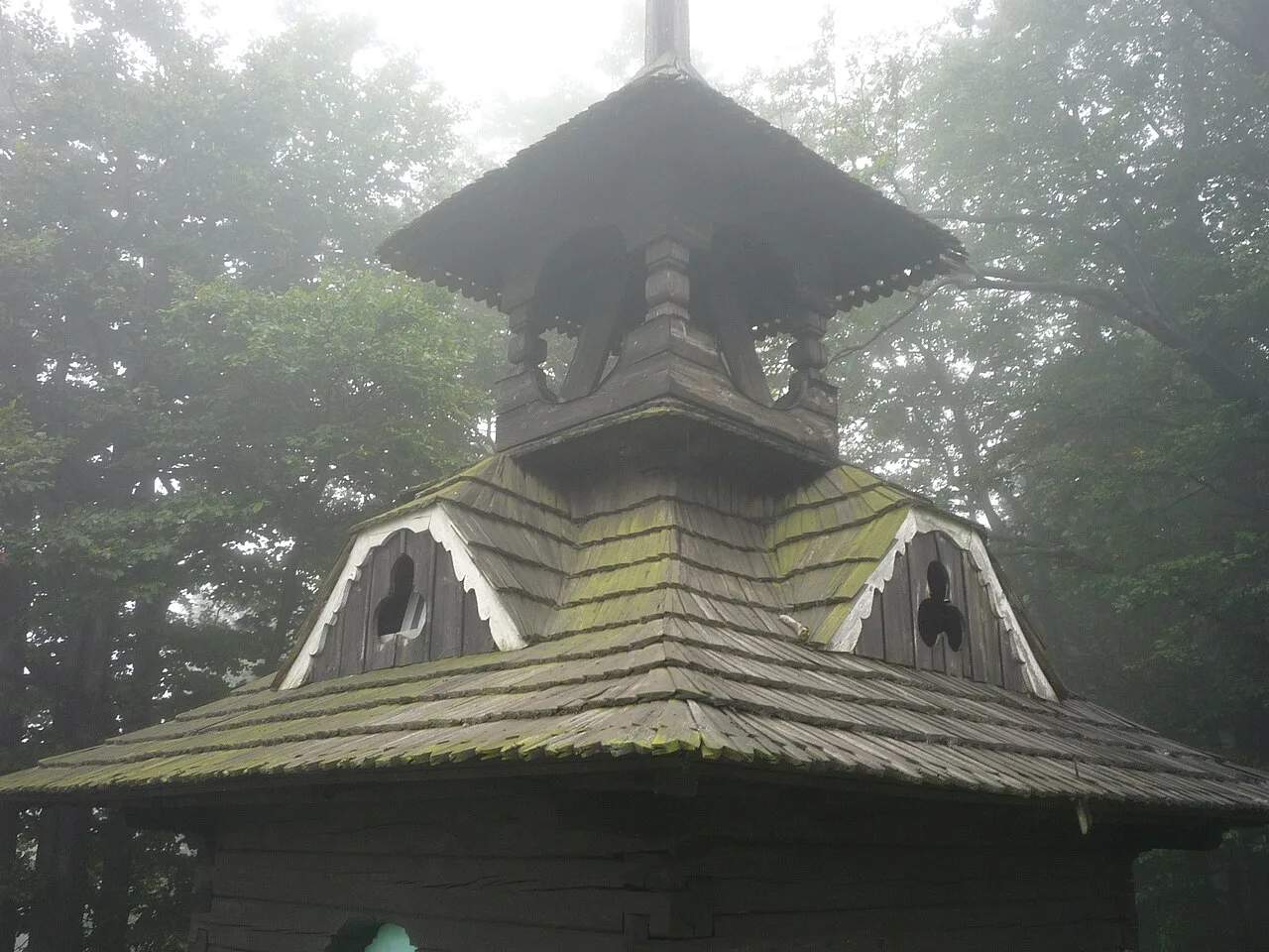 The wooden Wallachian belfry at Pustevny in fog.