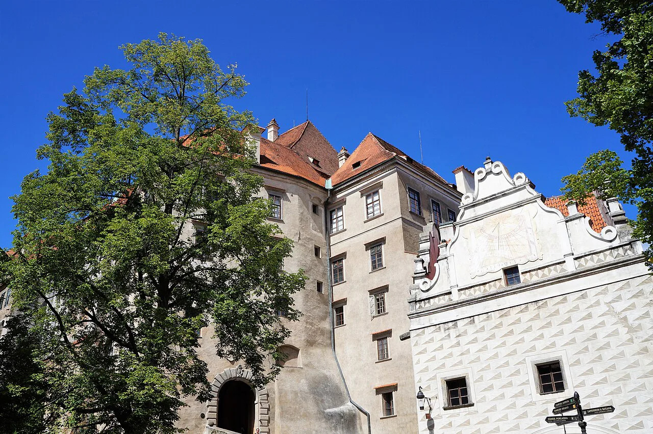 Český Krumlov Castle buildings framed by a tree, South Bohemia.