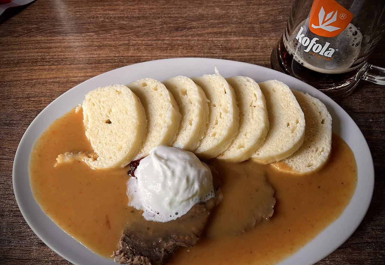 Svíčková with bread dumplings and whipped cream.