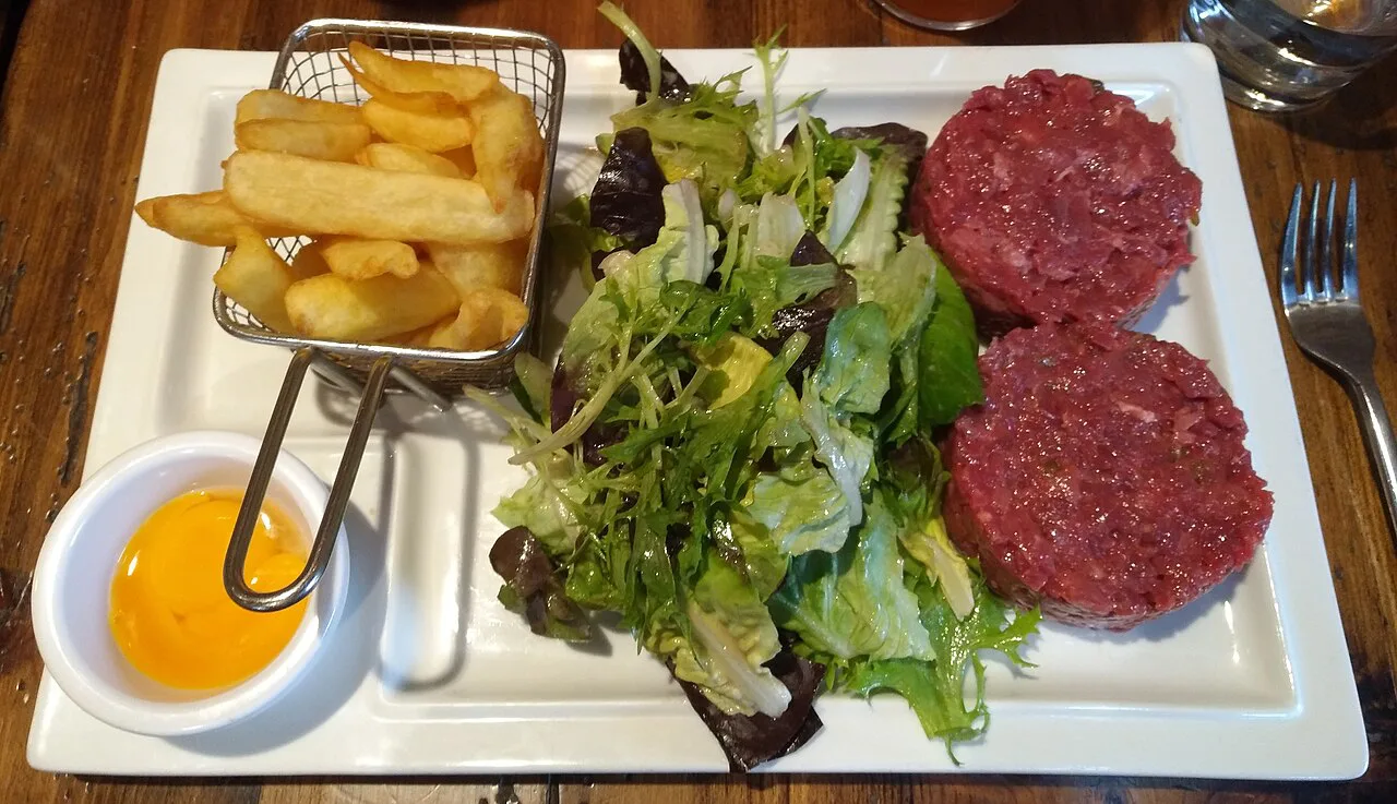 Steak tartare served with fries and salad.