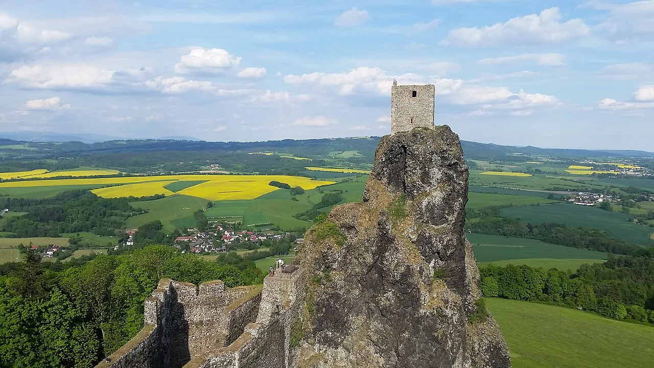 The ruins of Trosky Castle on their basalt peaks above the Bohemian Paradise countryside.